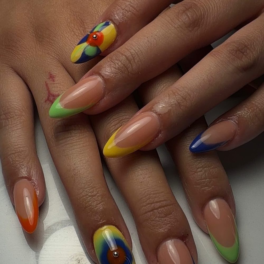 Colorful French tips with a floral accent nail